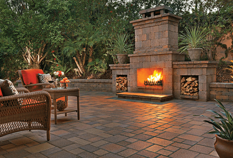 A stone firepit surrounded by paving stones