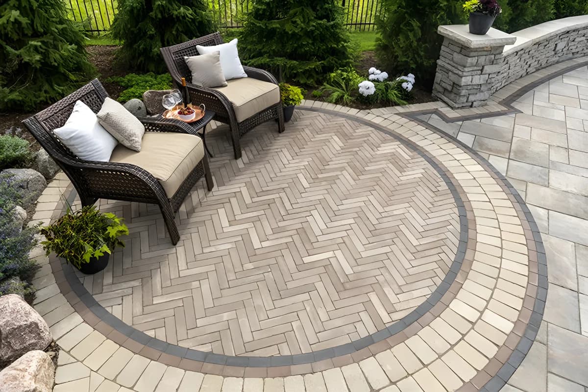 A large driveway paved with neutral-tone concrete pavers.